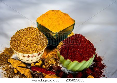 Close Up Of Three Basic Spices Of Indian Asian Food That Are Red Pepper Powder, Turmeric Powder And 