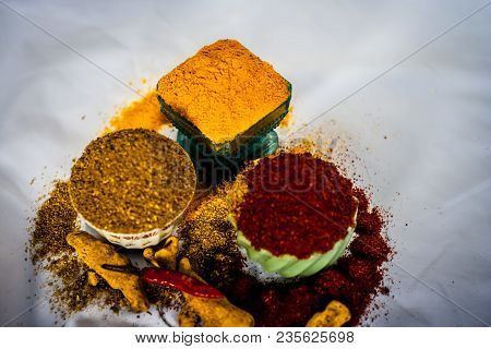 Close Up Of Three Basic Spices Of Indian Asian Food That Are Red Pepper Powder, Turmeric Powder And 