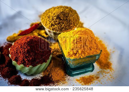 Close Up Of Three Basic Spices Of Indian Asian Food That Are Red Pepper Powder, Turmeric Powder And 