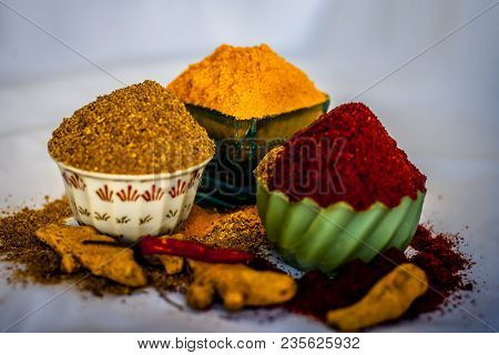 Close Up Of Three Basic Spices Of Indian Asian Food That Are Red Pepper Powder, Turmeric Powder And 