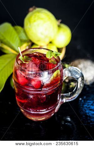 Close Up Of Popular Indian Shrabat Of Guava With Sugar And Masala In A Glass With Raw Fresh Guava On