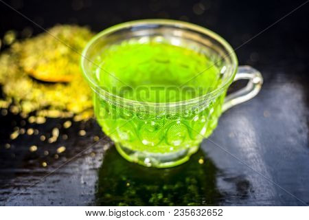 Closes Up Of Essential Tea Of Raw Fresh Fennel Seeds With Raw Fennel Seeds In A Transparent Cup On W
