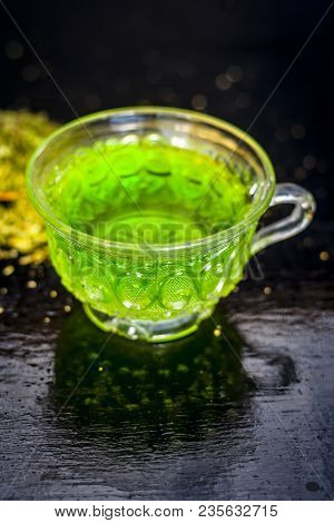 Closes Up Of Essential Tea Of Raw Fresh Fennel Seeds With Raw Fennel Seeds In A Transparent Cup On W
