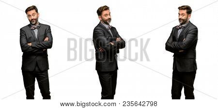 Middle age man, with beard and bow tie with crossed arms confident and happy with a big natural smile laughing