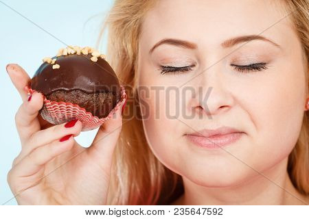 Diet, Sweets, Food Concept. Woman Holding Delicious Chocolate Cupcake With Peanut Frosting About To 