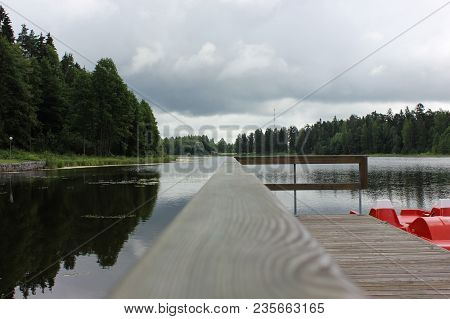 Beautiful Calm Lake Landscape With A Catamaran.