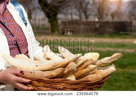 Hospitality Tourism Concept. Close Up Georgian Traditional Homemade Bread Lavash In Bread Masket Hol