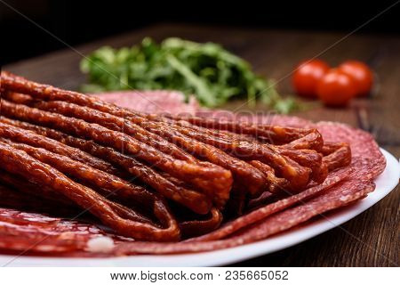 Macro Photo A Plate With Various Sausage Varieties. Rustic Style