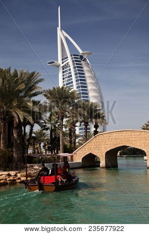 DUBAI, UAE - FEBRUARY, 2018: View on Burj Al Arab, the world only seven stars hotel seen from Madinat Jumeirah, a luxury resort which include hotels and souk spreding across over 40 hectars.