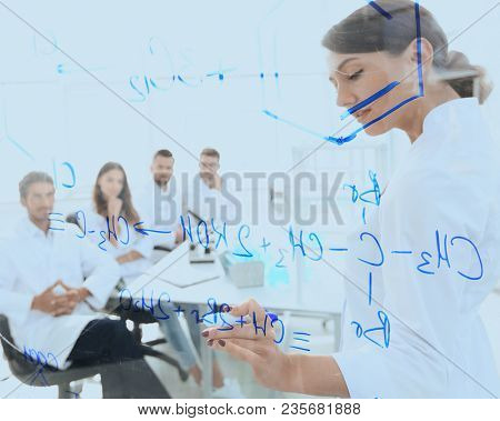 view through the transparent Board. female biochemist makes a re
