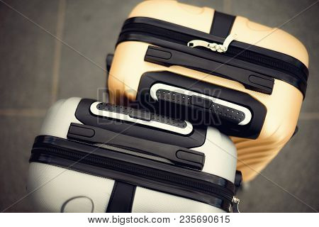 Two Suitcases On Grey Blurred Background. Summer Vacation And Travel Concept. Traveler Suitcase With