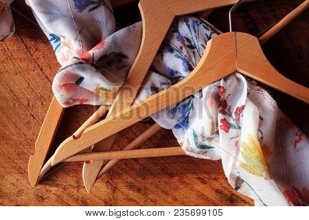 Wooden Empty Clothes Hangers On Wooden Background. What Nothing To Wear Concept. Woman Clothing