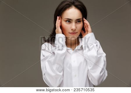 Beautiful Girl In A White Shirt Shows Emotions. On A Light Background.