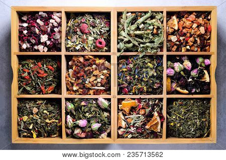 Assortment Of Dry Tea In Wooden Box. Tea Types: Green, Black, Floral, Herbal, Mint, Melissa, Ginger,