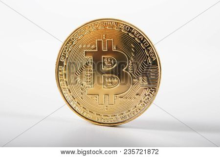 Golden Bitcoin On Isolated On White Table. A Visual Representation Of Digital Cryptocurrencies. Bitc