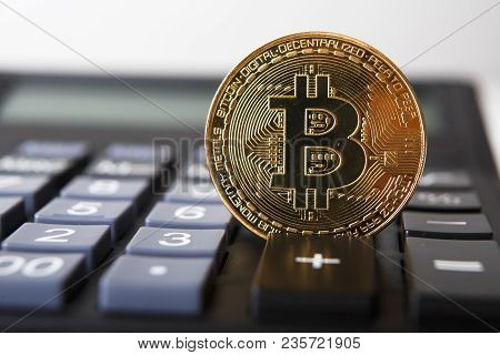 Bitcoin On The Keyboard Of The Calculator. Shallow Depth Of Field. A Visual Representation Of Digita