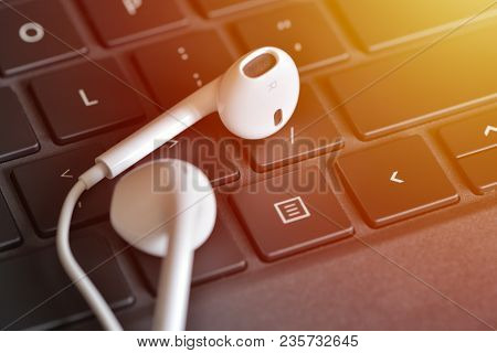 Electronic Devices. Headphones On The Keyboard. Online Straming Music Service Concept