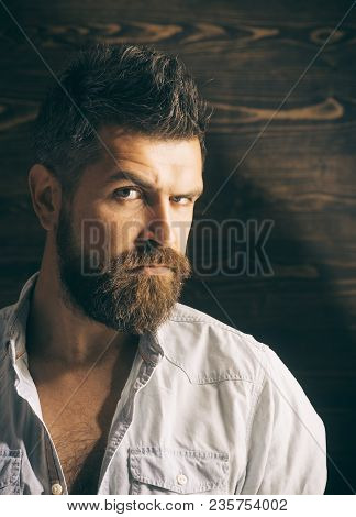 Barber And Hairdresser Salon. Man With Beard And Mustache On Wooden Background. Haircut Of Bearded M