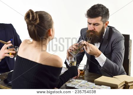 Company Engaged In Illegal Business. Men And Woman Sitting At Table With Piles Of Money. Illegal Dea