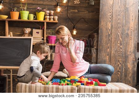 Mother And Son Play With Constructor. Childhood Concept. Nursery With Chalkboard On Background. Fami