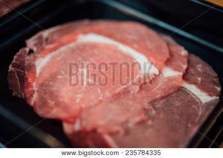 Beef Raw Meat Slides On Dish With Barbecue Sauce At Bbq. Yakiniku Grill Buffet Restaurant Japanese F
