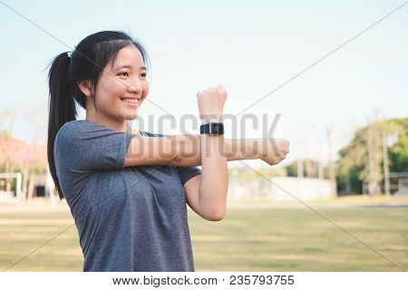 Young Woman Checking Progress On Smart Watch. Female Runner Looking At Smart Watch Heart Rate Monito