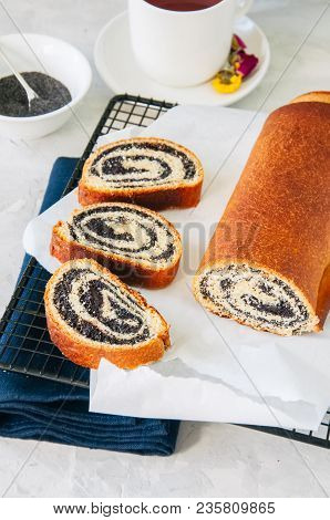 Traditional Polish Festive Pastry - Makowiec- Poppy Seed Roll Served On A Wire Rack. White Stone Bac