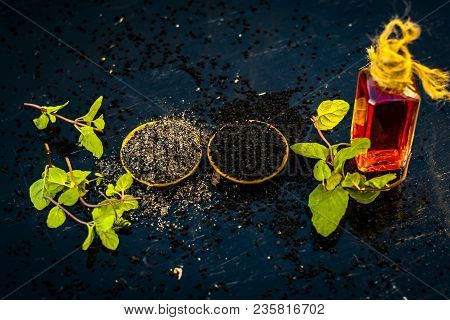 Close Up Of Kalonji, Roman Coriander, Mint Leaves, And Powder Of Kalonji With Its Extracted Oil For 