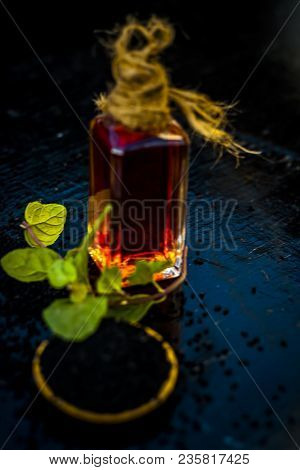 Close Up Of Kalonji, Roman Coriander, Mint Leaves, And Powder Of Kalonji With Its Extracted Oil For 