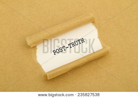 Post-truth Word Written Under Torn Paper Concept.