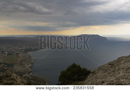 View Of Sudak (a Small Resort Town On The Black Sea Coast) From The Slope Of Mount Sokol. Summer, Ba