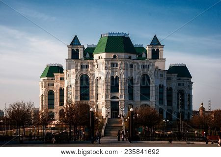 Astrakhan, Russia 12 Of April 2018: New Astrakhan Opera Theater In Sunny Spring Day With People Walk