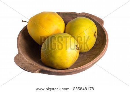 Closeup Of Rare Araza Fruit From The Amazon Area In Rustic Wood Bowl Isolated On White
