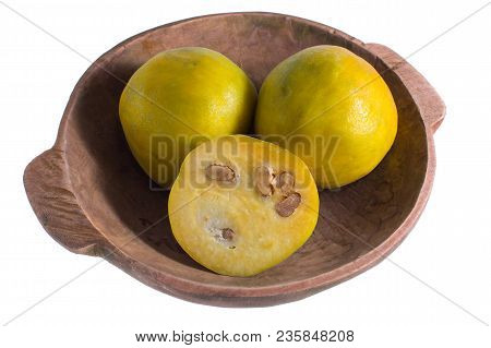Closeup Of Rare Araza Fruit From The Amazon Area In Rustic Wood Bowl Isolated On White
