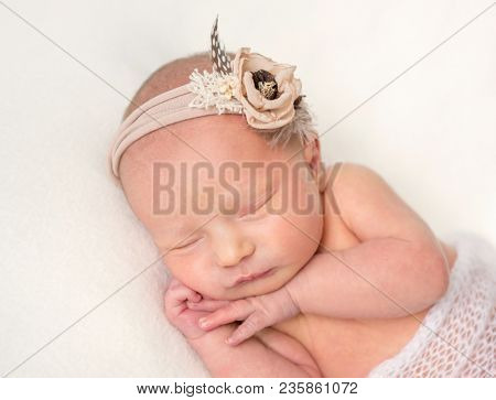 Cute sleeping newborn girl on white plaid