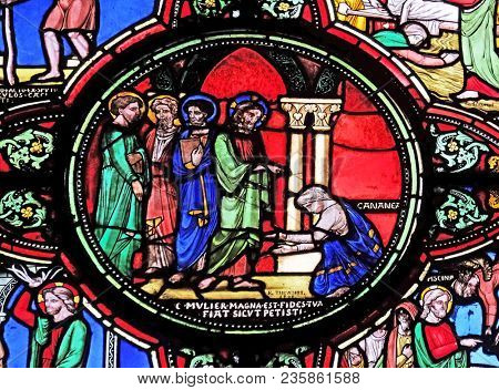 PARIS, FRANCE - JANUARY 09: Jesus and the Canaanite woman, stained glass window from Saint Germain-l'Auxerrois church in Paris, France on January 09, 2018.