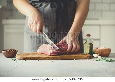 Wooman Hands Cutting Beef Meat On Wooden Chopping Board, Rosemary, Oil, Salt, Pepper. Girk Cooking P