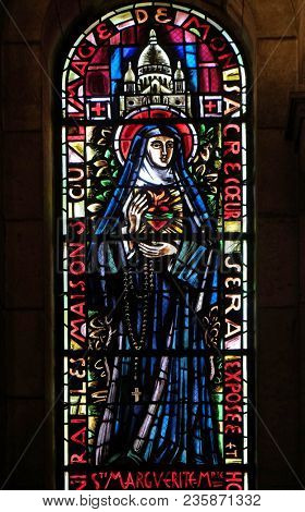PARIS, FRANCE - JANUARY 08: Saint Margaret Mary Alacoque, stained glass window in Basilica of the Sacre Coeur, dedicated to the Sacred Heart of Jesus in Paris, France on January 08, 2018.