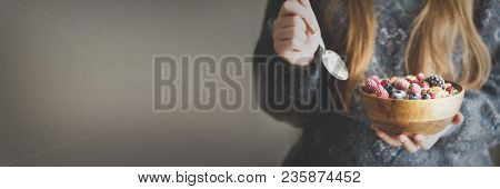 Woman Hands Holding Oatmeal Porridge With Frozen Berries, Almonds In Wooden Bowl. Banner. Healthy Br