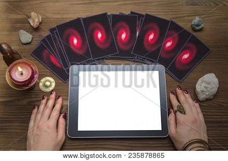 Online Future Reading Concept. Tarot Cards And Tablet Computer With Blank Screen On Fortune Teller D