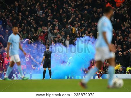 MANCHESTER, ENGLAND - APRIL 10: The Referee Antonio Mateu Lahoz stands near the smoke bomb during the Champions League quarter final match between Manchester City and Liverpool  on April 10, 2018 