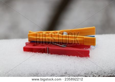 A Three Pegs Lying On Parapet Who Is Covered By  White Snow