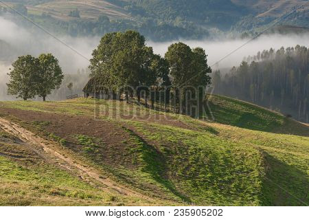 Beautiful Mountain Landscape Of A Foggy Morning With And Old House And Trees, Dumesti, Salciua, Apus
