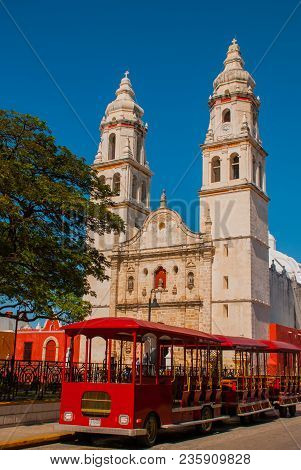 Campeche, Mexico Independence Plaza, Tourist Trains And Cathedral On The Opposite Side Of The Square
