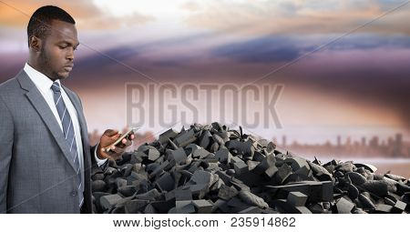 Broken concrete stone pile and businessman on phone in cityscape