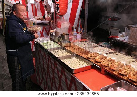 Chichibu, Japan - December 3, 2016: Vendor Prepares Takoyaki Street Food At Chichibu Night Festival 