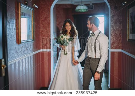 Happy Bride And Bearded Groom On The Wedding Walk In The Modern Hotel Hall On Wedding