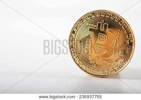 Golden Bitcoin On Isolated On White Table. A Visual Representation Of Digital Cryptocurrencies. Bitc