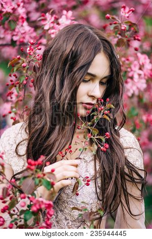 Beautiful Girl Near Sakura, Sniffing Pink Flowers Of The Tree, Looking Down, Closeup