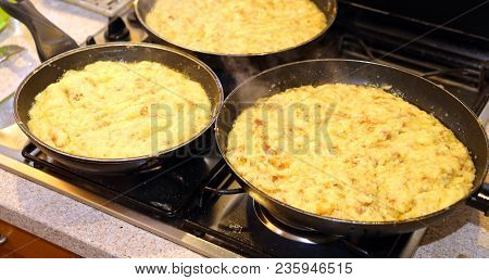 Big Pans With The Food Named Frico A Typical Italian Dish With Potatoes And Cheese